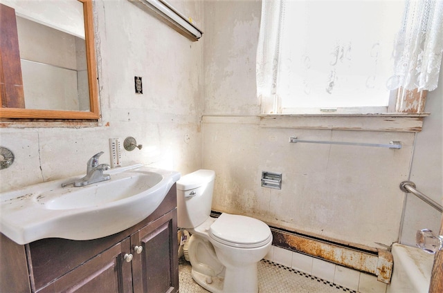 11333 Stony Creek Rd, Milan, MI 48160 - bathroom featuring toilet, vanity, decorative backsplash, and tile walls