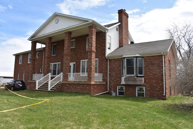 11333 Stony Creek Rd, Milan, MI 48160 - rear view of property featuring brick siding, a chimney, and a lawn