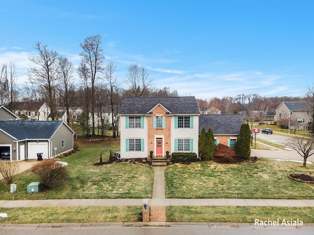 view of front of house with a garage, driveway, and a front lawn