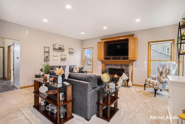 living room with recessed lighting, light carpet, a fireplace, and baseboards