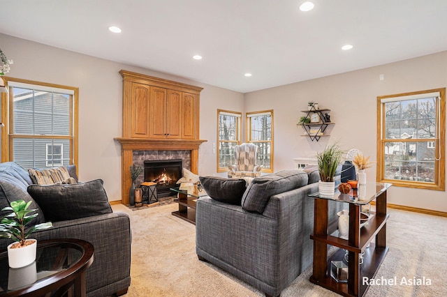 living room with light carpet, a fireplace, baseboards, and recessed lighting