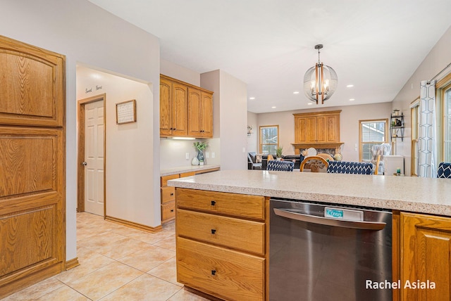 kitchen with hanging light fixtures, light countertops, dishwasher, and light tile patterned flooring