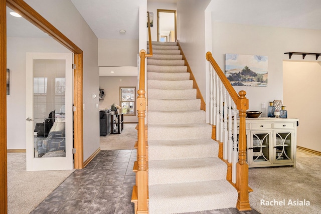 stairs featuring carpet floors and baseboards