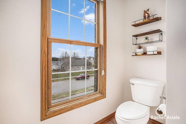 bathroom featuring toilet and baseboards