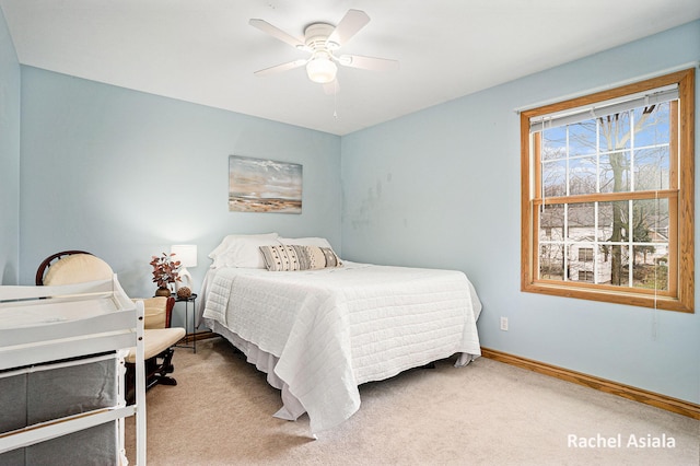 bedroom with carpet, a ceiling fan, and baseboards