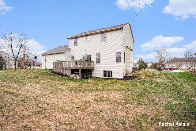 rear view of house with a lawn and a deck