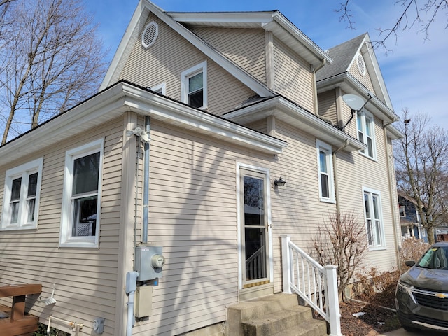 back of property featuring entry steps