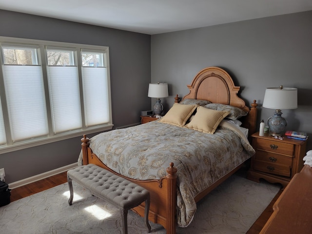 bedroom with wood finished floors and baseboards