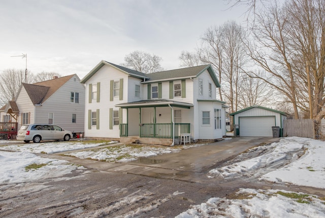 view of front of home with a porch, an outbuilding, and a detached garage