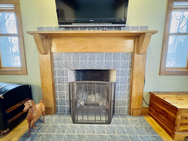 interior details featuring a tiled fireplace