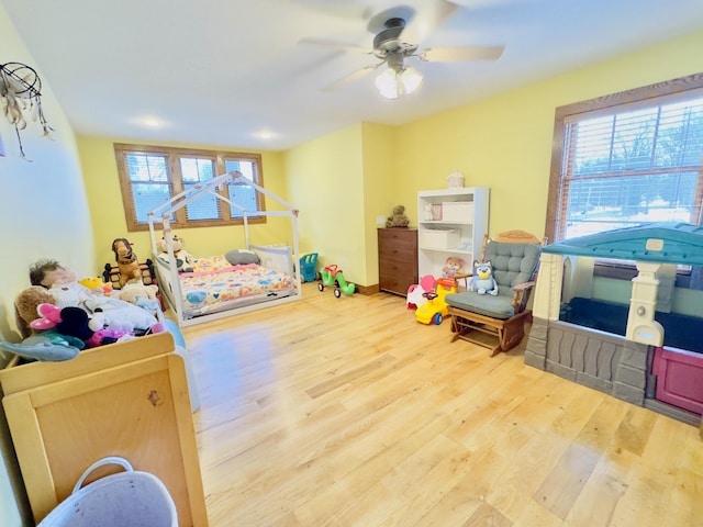 rec room with ceiling fan, plenty of natural light, and light wood-style floors