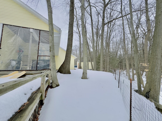 snowy yard with fence