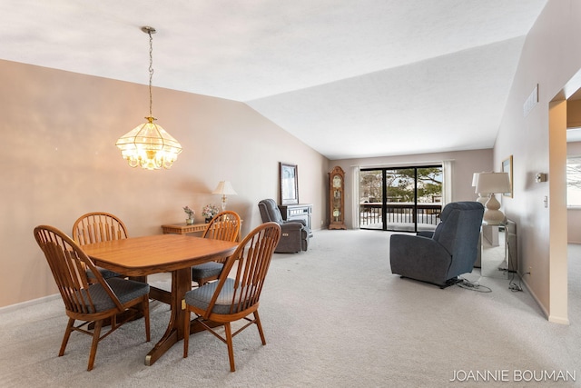 dining room featuring lofted ceiling, light colored carpet, a notable chandelier, visible vents, and baseboards