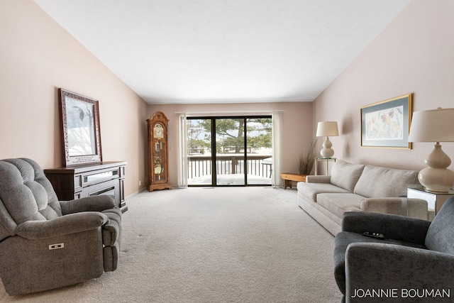 living area with lofted ceiling and carpet flooring