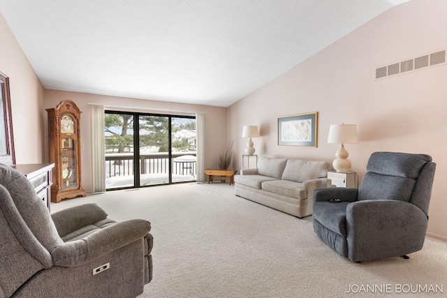 carpeted living room with lofted ceiling and visible vents