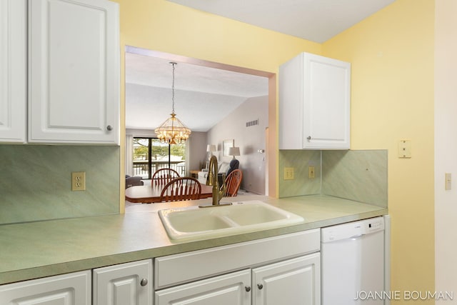 kitchen with a chandelier, white dishwasher, light countertops, white cabinetry, and a sink