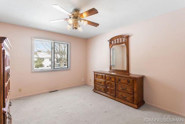 carpeted bedroom featuring ceiling fan and baseboards