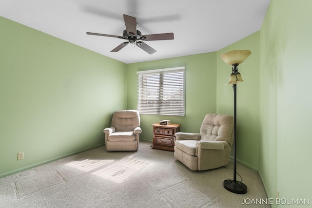 sitting room featuring carpet flooring, a ceiling fan, and baseboards