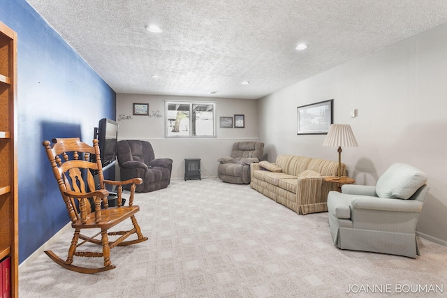 living room with a textured ceiling, carpet flooring, and recessed lighting