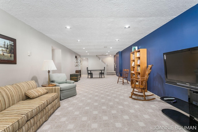 living room featuring recessed lighting, light colored carpet, and a textured ceiling