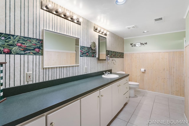 bathroom featuring visible vents, wainscoting, toilet, tile patterned flooring, and vanity