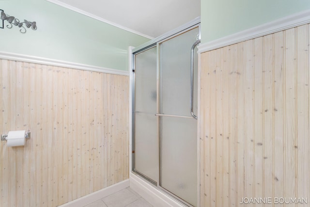 bathroom with a stall shower and tile patterned flooring