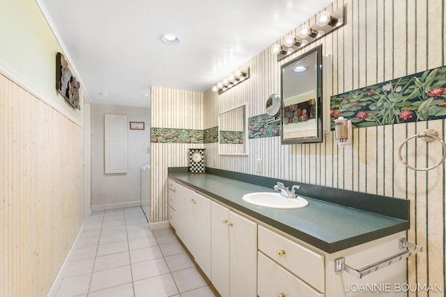 bathroom with baseboards, wallpapered walls, vanity, and tile patterned floors