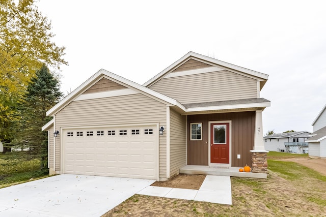 view of front facade with an attached garage, driveway, and board and batten siding