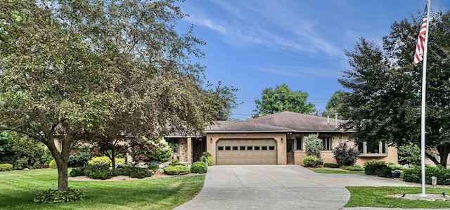 ranch-style home with concrete driveway, a front lawn, an attached garage, and brick siding