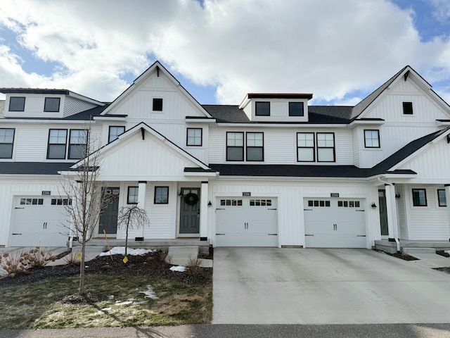 view of front of house featuring a garage, driveway, a shingled roof, and board and batten siding