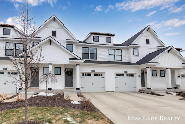 modern inspired farmhouse with board and batten siding, covered porch, an attached garage, and concrete driveway