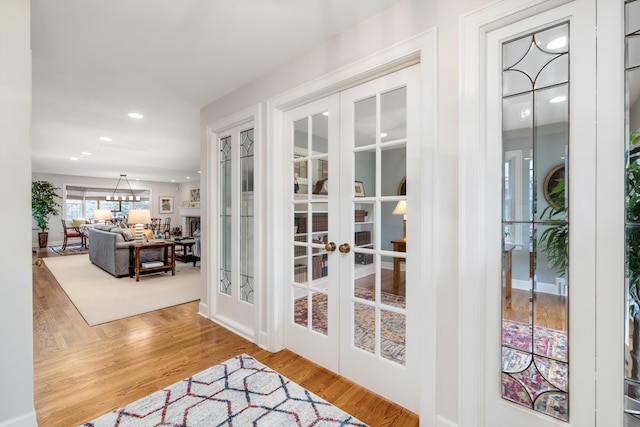 entryway featuring recessed lighting, wood finished floors, and french doors