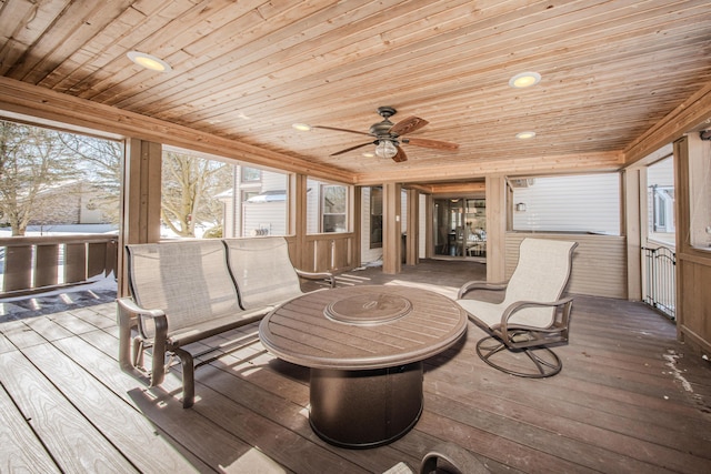 sunroom featuring ceiling fan, wooden ceiling, and a wealth of natural light