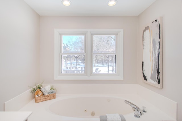 bathroom featuring a whirlpool tub and recessed lighting