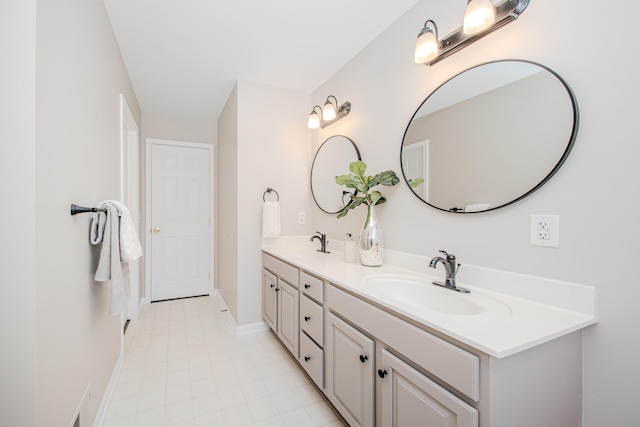 full bathroom with double vanity, visible vents, baseboards, and a sink