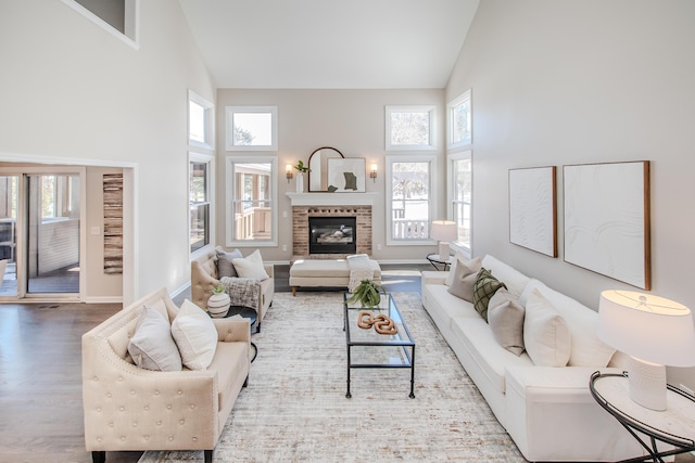 living area featuring high vaulted ceiling, plenty of natural light, and a fireplace