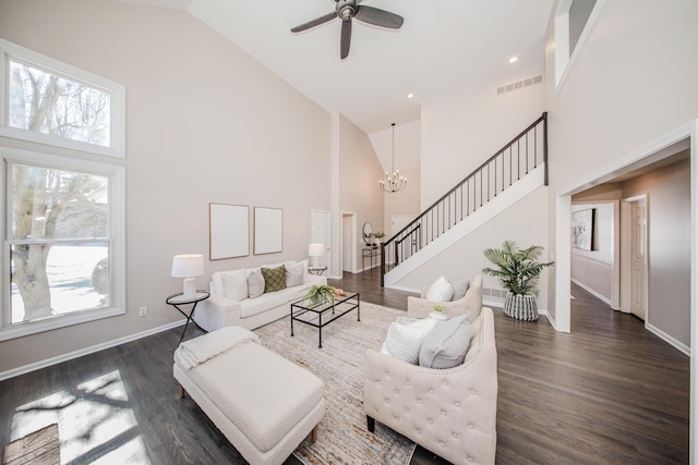 living area featuring stairway, visible vents, dark wood finished floors, and high vaulted ceiling