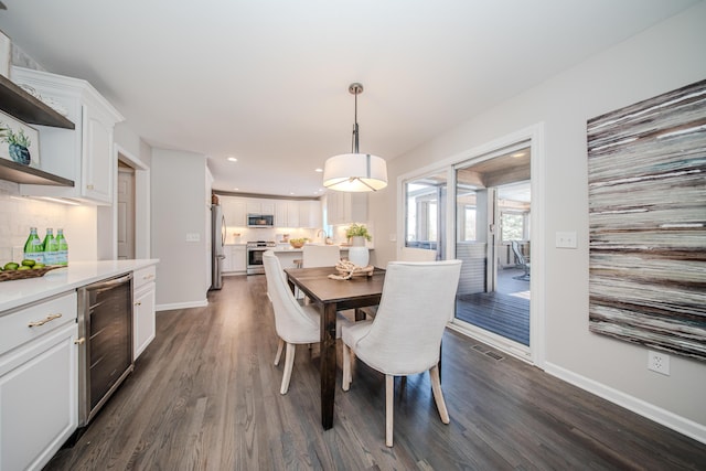 dining space featuring dark wood-style floors, wine cooler, recessed lighting, visible vents, and baseboards