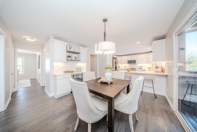 dining area featuring recessed lighting, light wood-style flooring, and baseboards