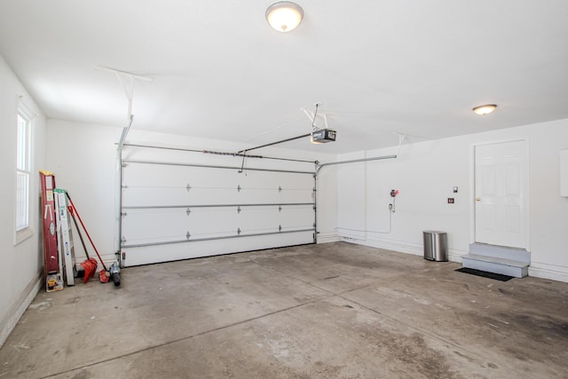 garage with baseboards and a garage door opener