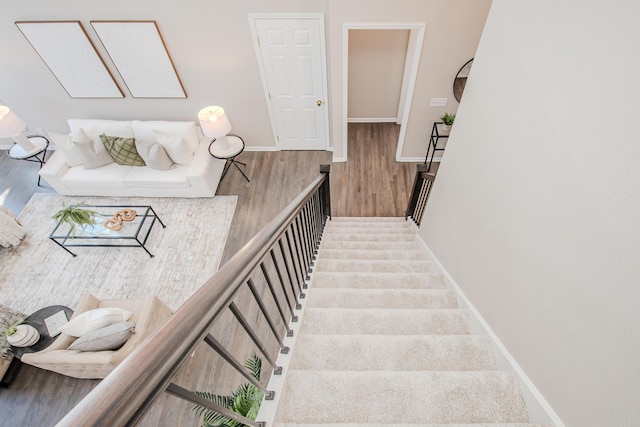 stairs featuring baseboards and wood finished floors