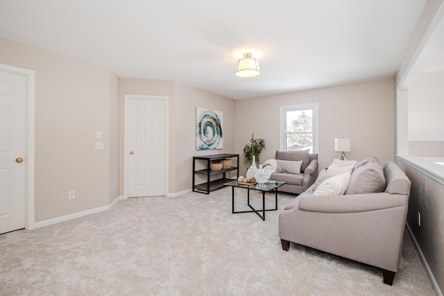 living room with baseboards and light colored carpet