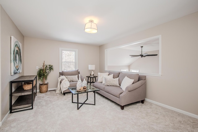 living room featuring light carpet, ceiling fan, and baseboards