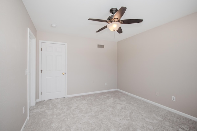 unfurnished room featuring light carpet, ceiling fan, visible vents, and baseboards