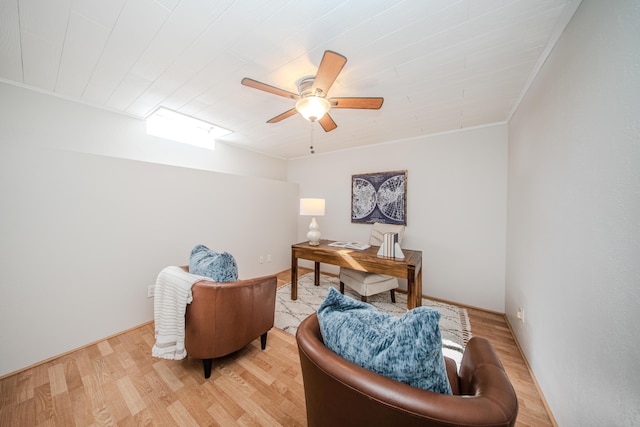 home office with light wood finished floors, ceiling fan, and ornamental molding