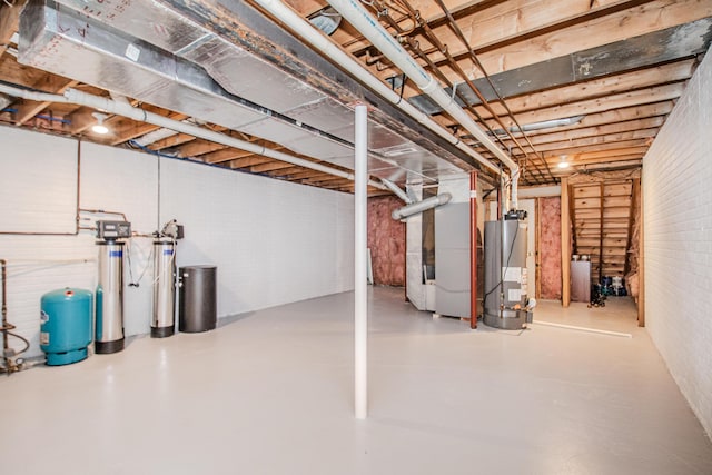 unfinished basement with water heater and heating unit