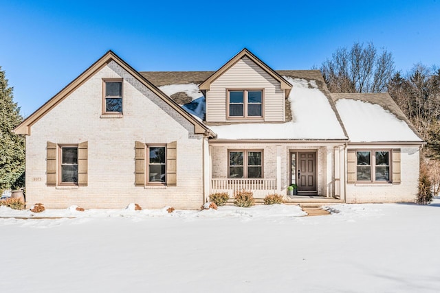 view of front of house featuring a porch and brick siding