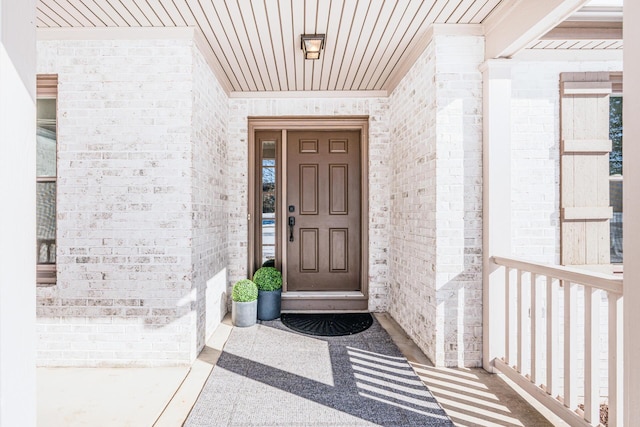 property entrance with brick siding