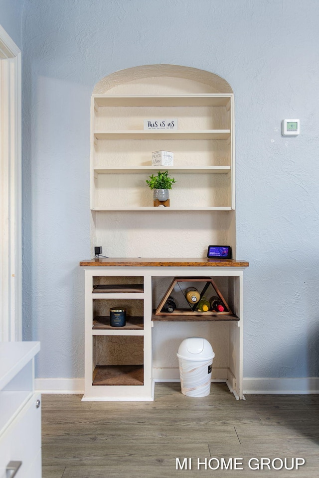 room details featuring baseboards and wood finished floors