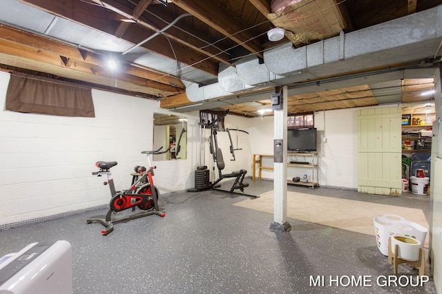 workout area with concrete block wall